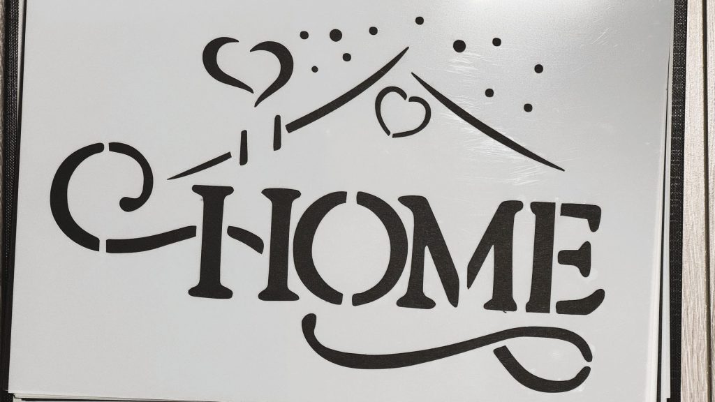 Dekorativna šablona s natpisom home i ornamentalnim linijama